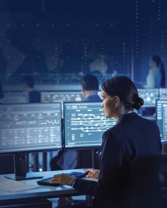 Woman working with multiple monitors